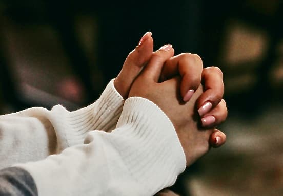 Hands open in prayer